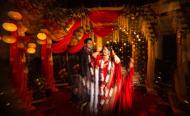 Bengali wedding ceremony with bride in traditional red Benarasi saree